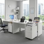 A collaborative 4-person office workstation cluster using white rectangular desks, featuring a mobile pedestal placed beside one of the desks serving as a convenient stand for a printer.