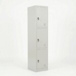 Front view of a tall three-compartment light grey steel locker with three vertical doors, each featuring air vents and an individual key lock.