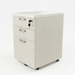 Three-quarter view of a Cherry wooden mobile pedestal showing woodgrain laminate, 3 drawers with curved handles, and 5 base castors.