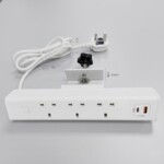 Rear technical view of the white VF Desktop Power Module showing the mounting clamp for desks up to 30mm, a 1.6m coiled power cable with a UK plug, and a front-facing panel with 3 UK sockets and a USB-C PD 20W charging port.