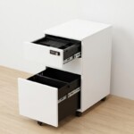 Open-drawer view of the iSimply 300mm narrow white pedestal showing a top stationery tray and a deep bottom filing drawer with smooth steel ball-bearing runners on a light wood floor.